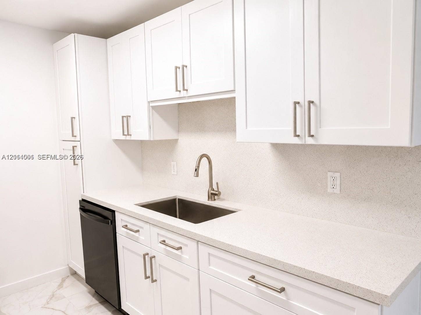 2611 SW 13th Avenue, #1-2, Fort Lauderdale, Fort Lauderdale, FL 33315 Kitchen featuring white shaker-style cabinetry, solid-surface countertops, a stainless steel undermount sink, brushed nickel faucet, and a black dishwasher