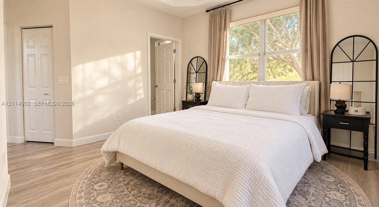 1495 NE 33rd Avenue, #107, Homestead, Homestead, FL 33033 Tray ceiling, wood-finish flooring, and large window with natural light