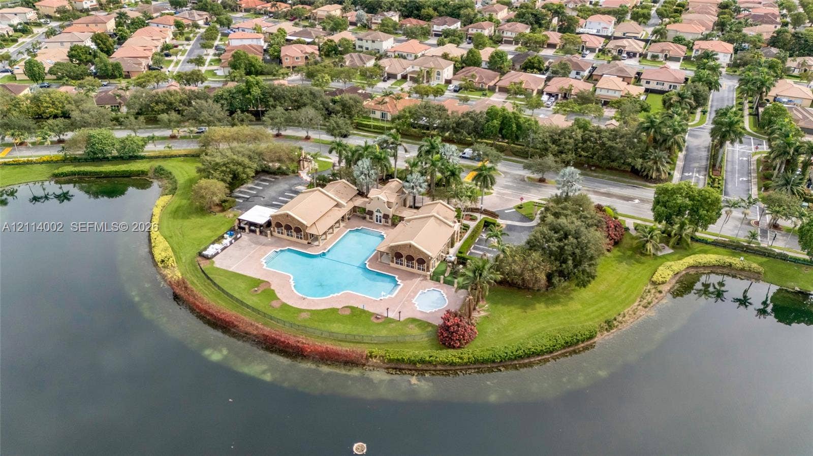 1495 NE 33rd Avenue, #107, Homestead, Homestead, FL 33033 Waterfront clubhouse facility featuring an expansive swimming pool, integrated spa, paved pool deck, and perimeter landscaping