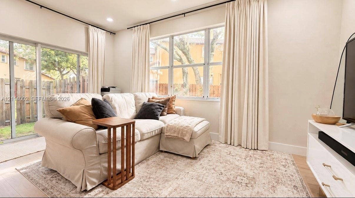 1495 NE 33rd Avenue, #107, Homestead, Homestead, FL 33033 Living space featuring floor-to-ceiling windows, sliding glass door, recessed lighting, and light-toned wood-finish flooring