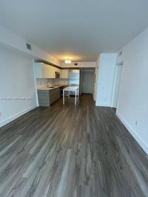 1300 Brickell Bay Drive, #1000, Miami, Miami, FL 33131 Kitchen featuring two-tone cabinetry, stainless steel refrigerator, stone countertops, and wood-finish flooring