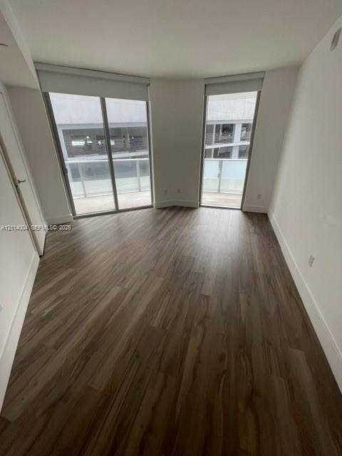 1300 Brickell Bay Drive, #1000, Miami, Miami, FL 33131 Wood-finish flooring, dual floor-to-ceiling glass sliding doors, and private balcony access