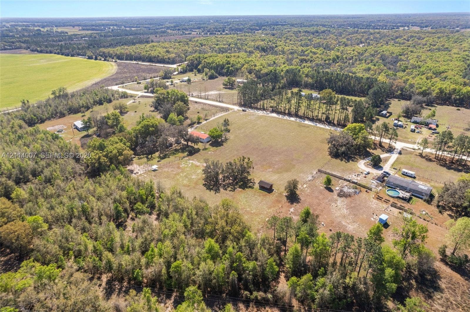 5600 SE 39th Street, Trenton, FL 32693 Expansive acreage featuring mature tree lines, open pastoral land, and a paved road frontage