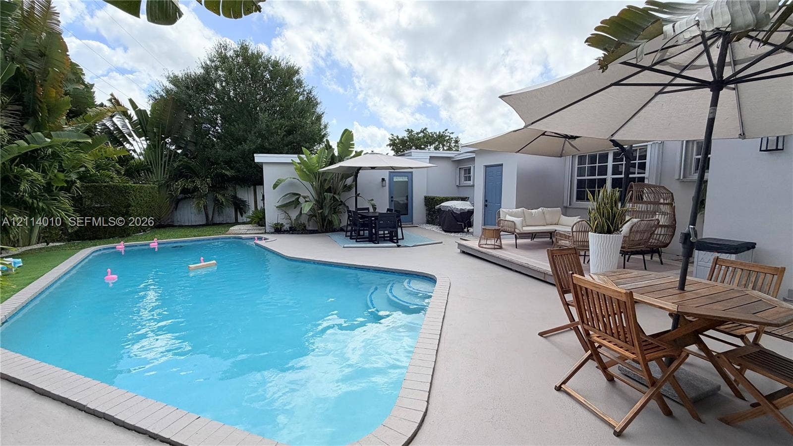 1161-1163 SW 30th Street, Fort Lauderdale, FL 33315 In-ground swimming pool with integrated steps, expansive paved patio, and mature landscaping