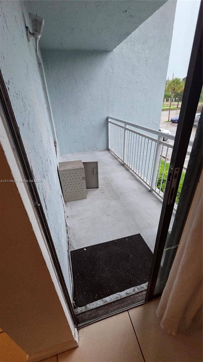 505 S Pine Island Road, #B205, Plantation, FL 33324 Covered balcony featuring concrete flooring and white metal railing