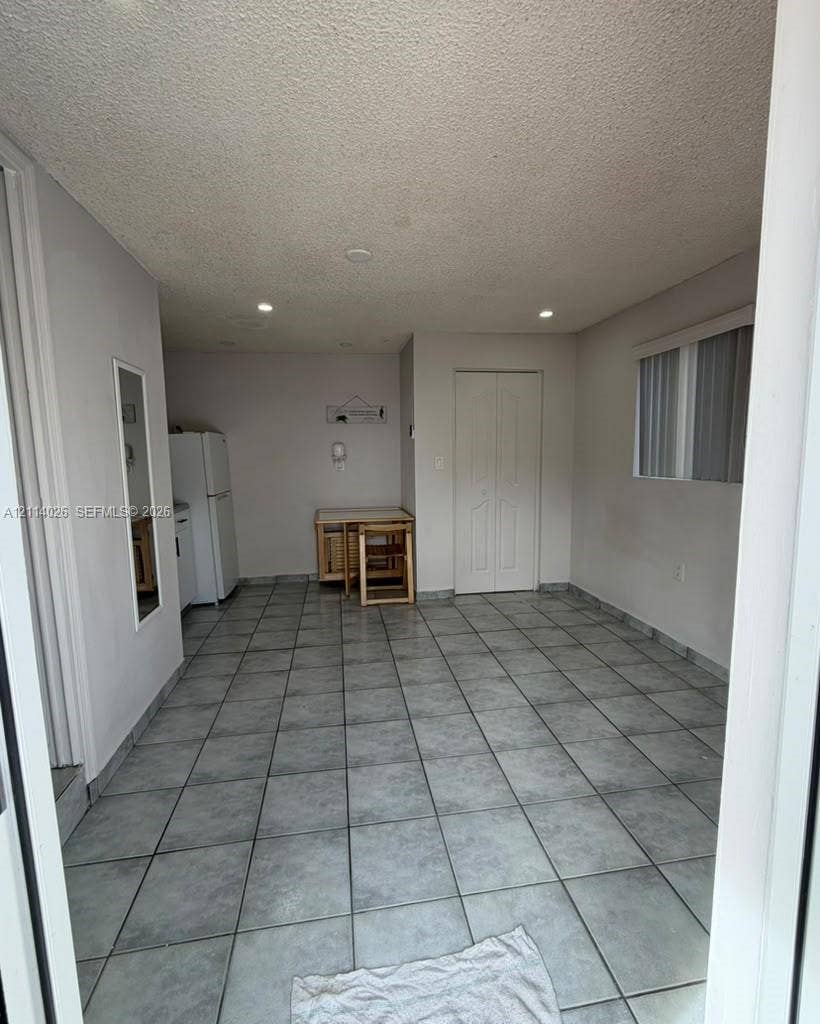 11511 SW 180th Street, #Studio, Miami, Miami, FL 33157 Large-format tile flooring, recessed ceiling lighting, and double-door closet with paneled detailing