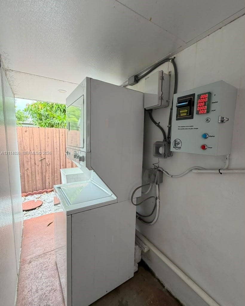 11511 SW 180th Street, #Studio, Miami, Miami, FL 33157 Stacked white laundry unit featuring a top-load washer and a control panel for integrated utility management