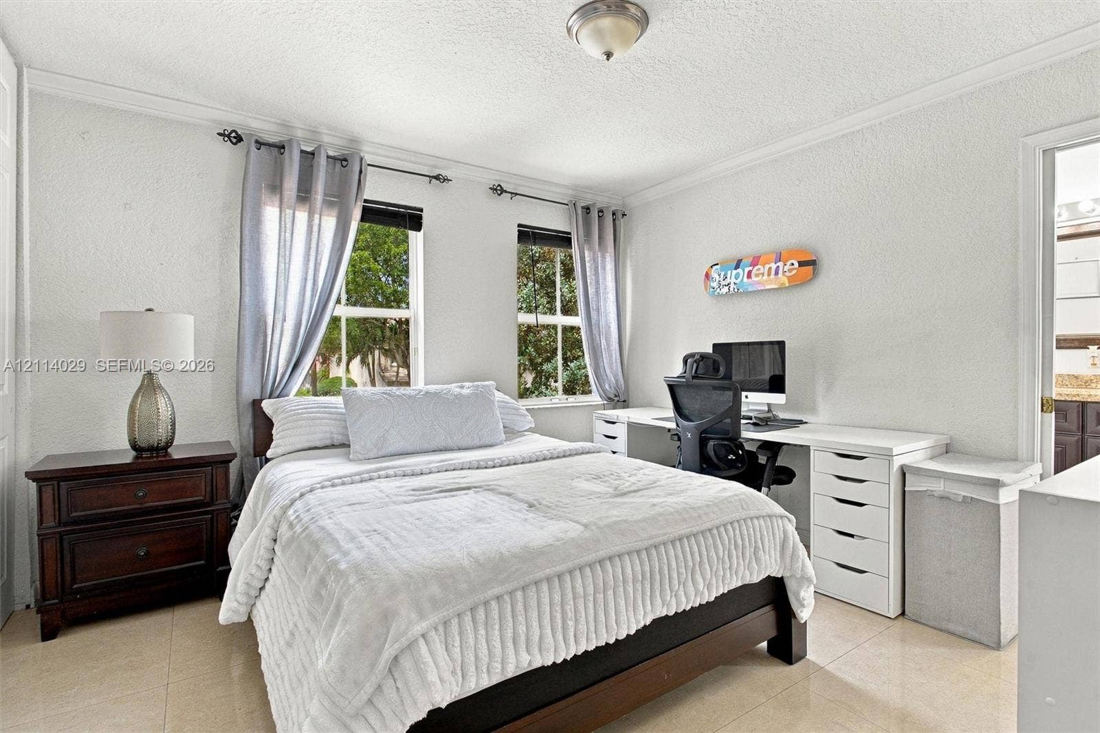 5257 SW 158th Avenue, Miramar, FL 33027 Room featuring neutral tile flooring, crown molding, and dual windows with consistent natural lighting