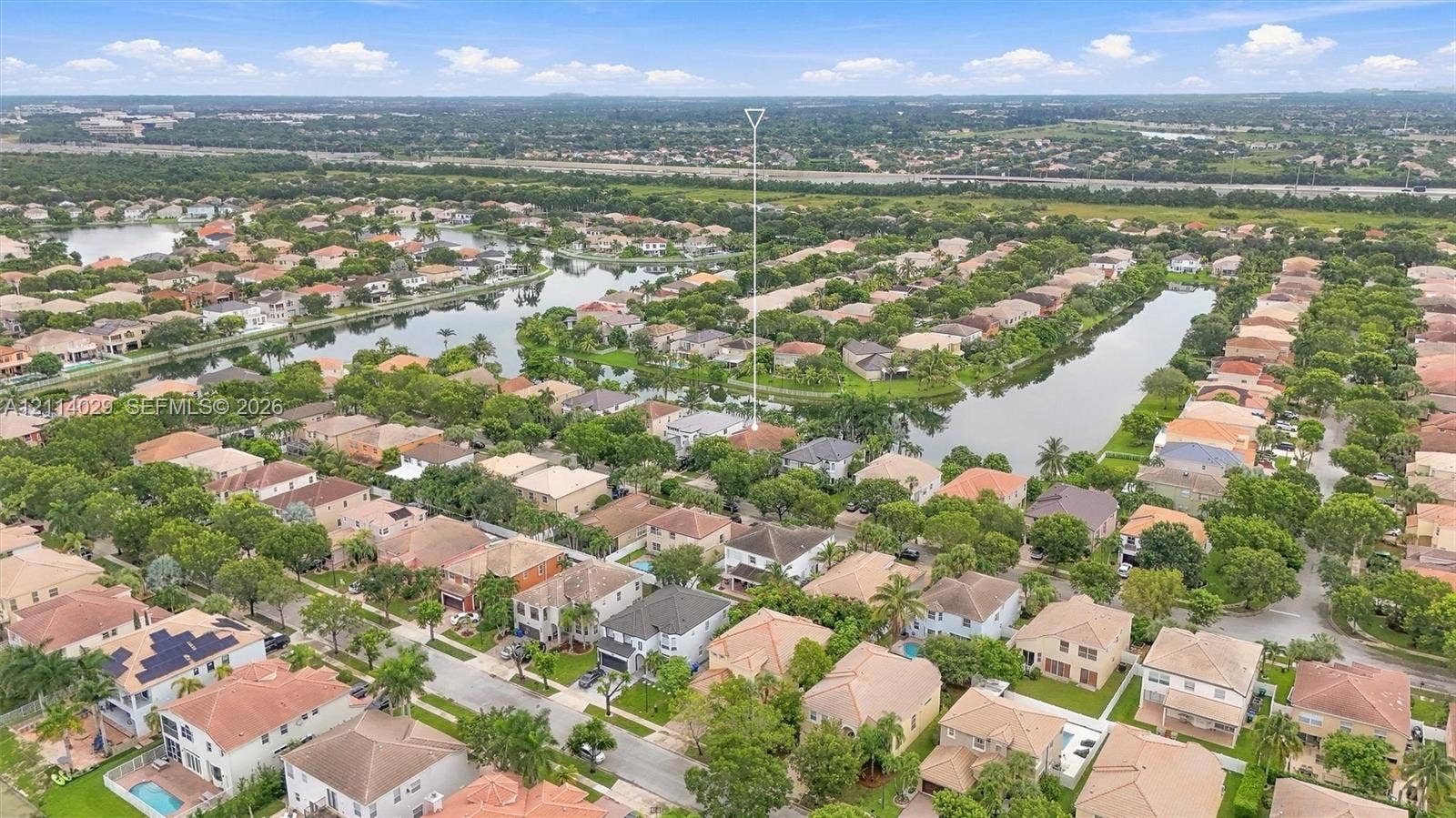 5257 SW 158th Avenue, Miramar, FL 33027 Aerial perspective of residential community featuring winding waterfront canals, mature trees, and interconnected paved thoroughfares