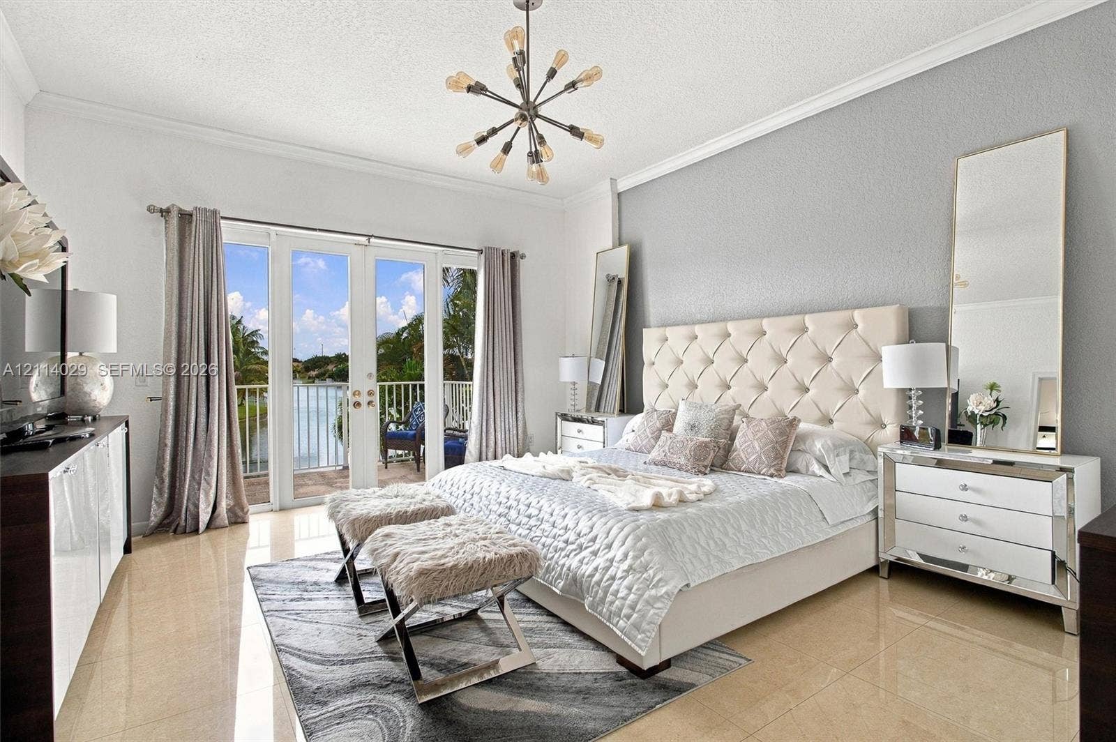 5257 SW 158th Avenue, Miramar, FL 33027 Polished tile flooring, crown molding, multi-light modern chandelier, and double glass-paned doors opening to a private balcony