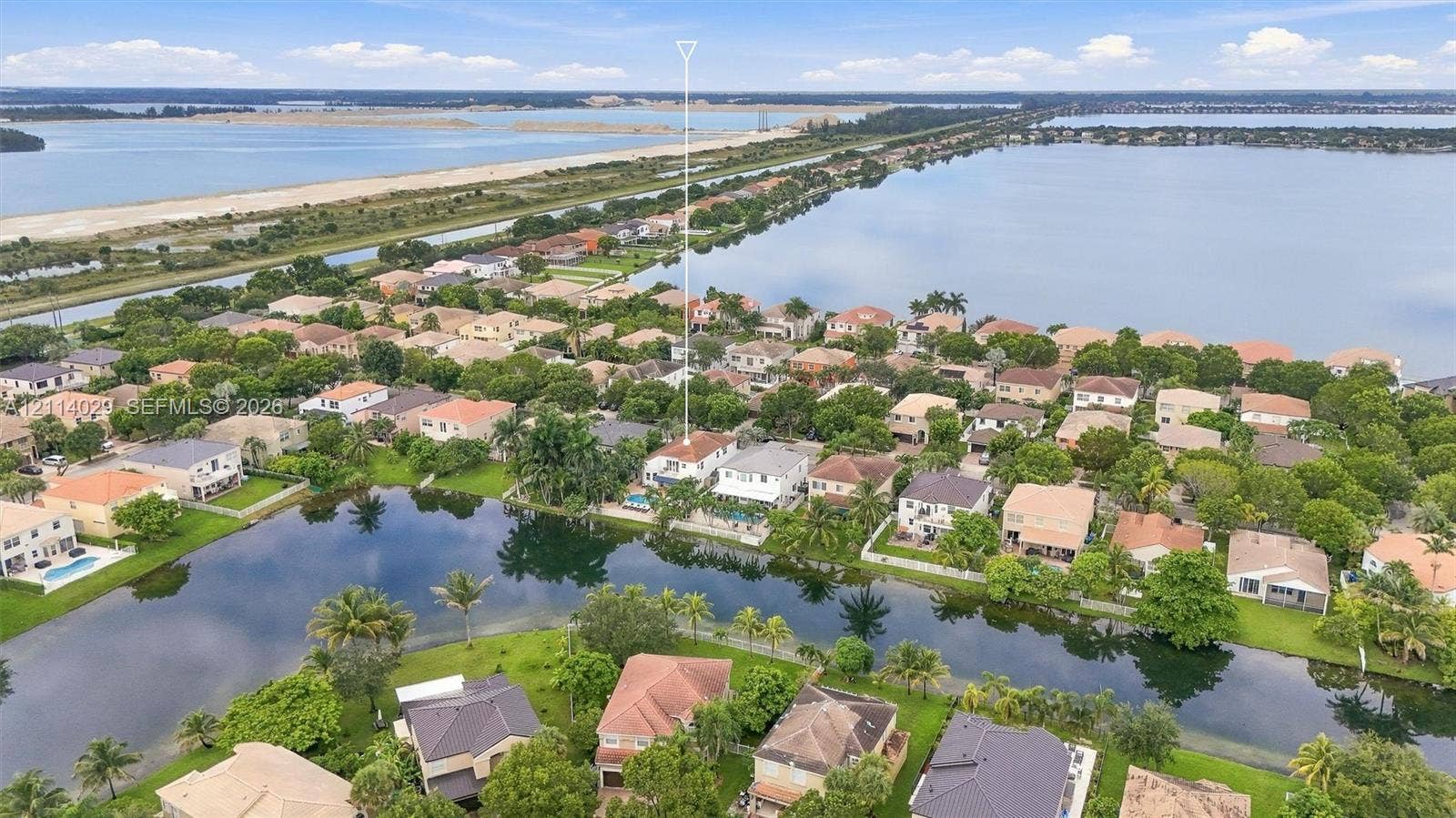 5257 SW 158th Avenue, Miramar, FL 33027 Aerial perspective featuring waterfront placement, private swimming pool, concrete tile roofing, and extensive surrounding water bodies