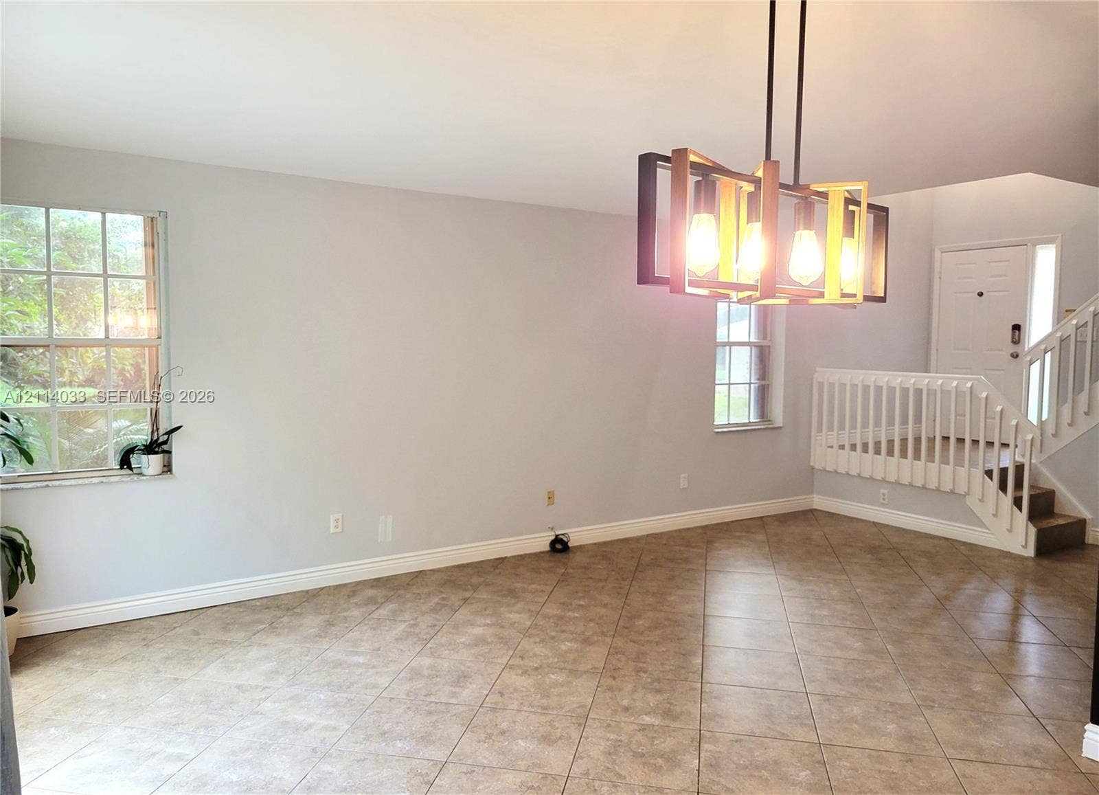 683 NW 88th Drive, Coral Springs, Coral Springs, FL 33071 Tile flooring, multi-light rectangular pendant fixture, grid-pattern windows, and staircase with white railings