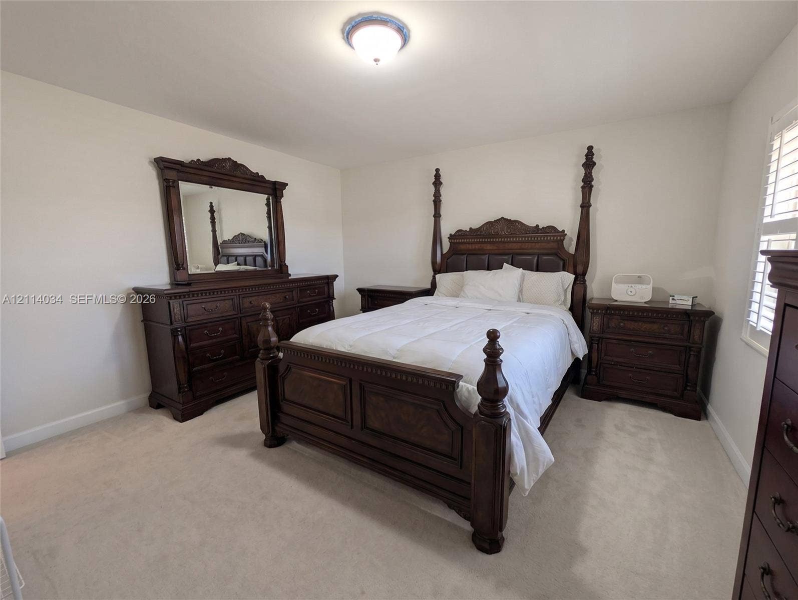 8460 Casa Del Lago, #H, Boca Raton, Boca Raton, FL 33433 Second bedroom with neutral-toned wall paint, plush carpeting, and plantation-style window shutters