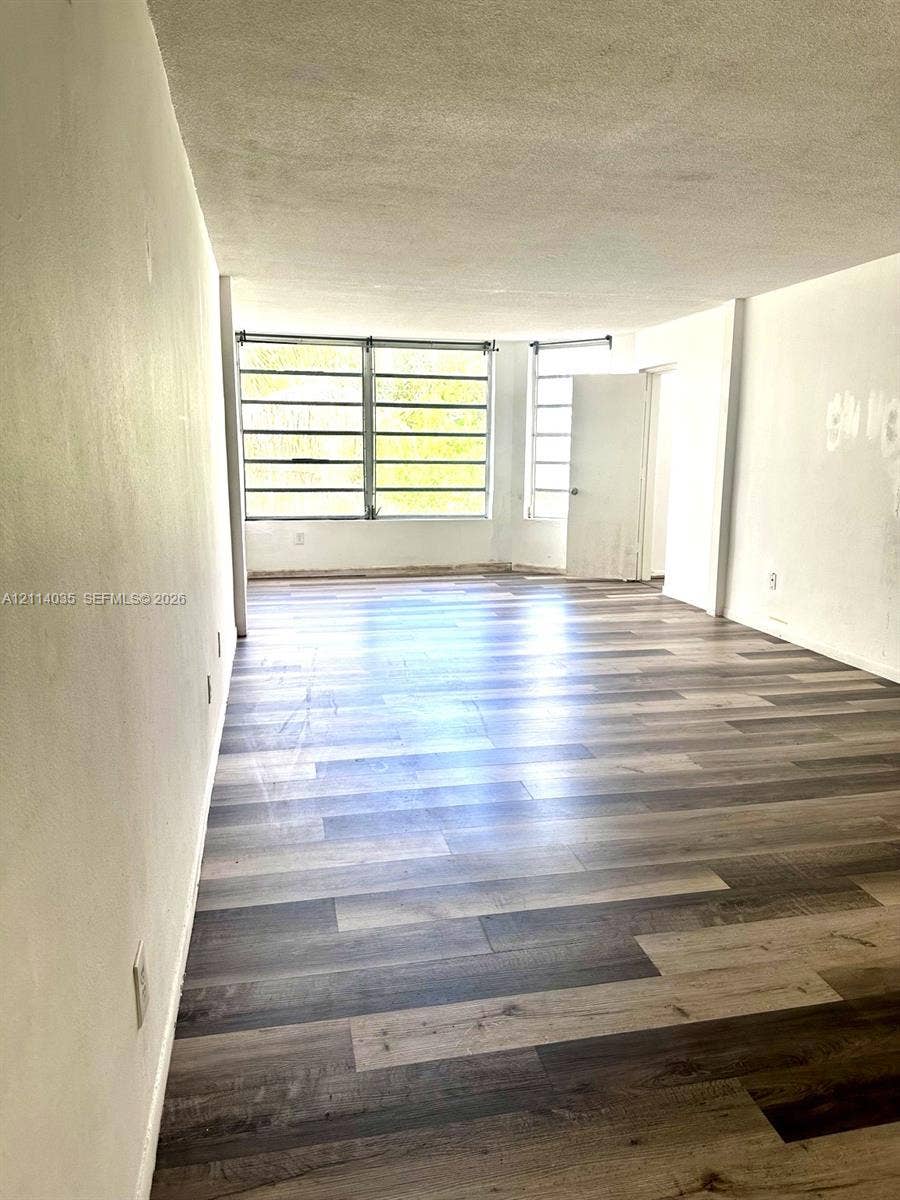 1501 NE 191st Street, #C312, Miami, Miami, FL 33179 Interior space featuring wood-finish flooring and large multi-pane windows