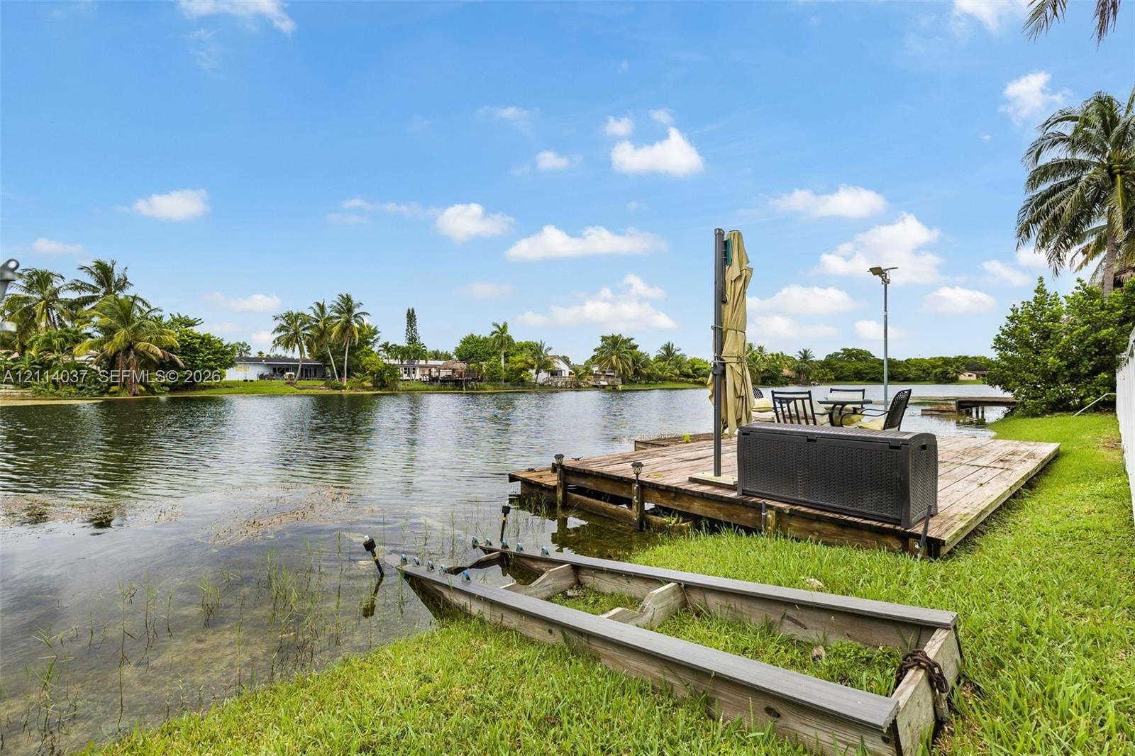 8436 SW 143rd Avenue, Miami, FL 33183 Waterfront property featuring a wood-plank dock, canal access, and expansive green space