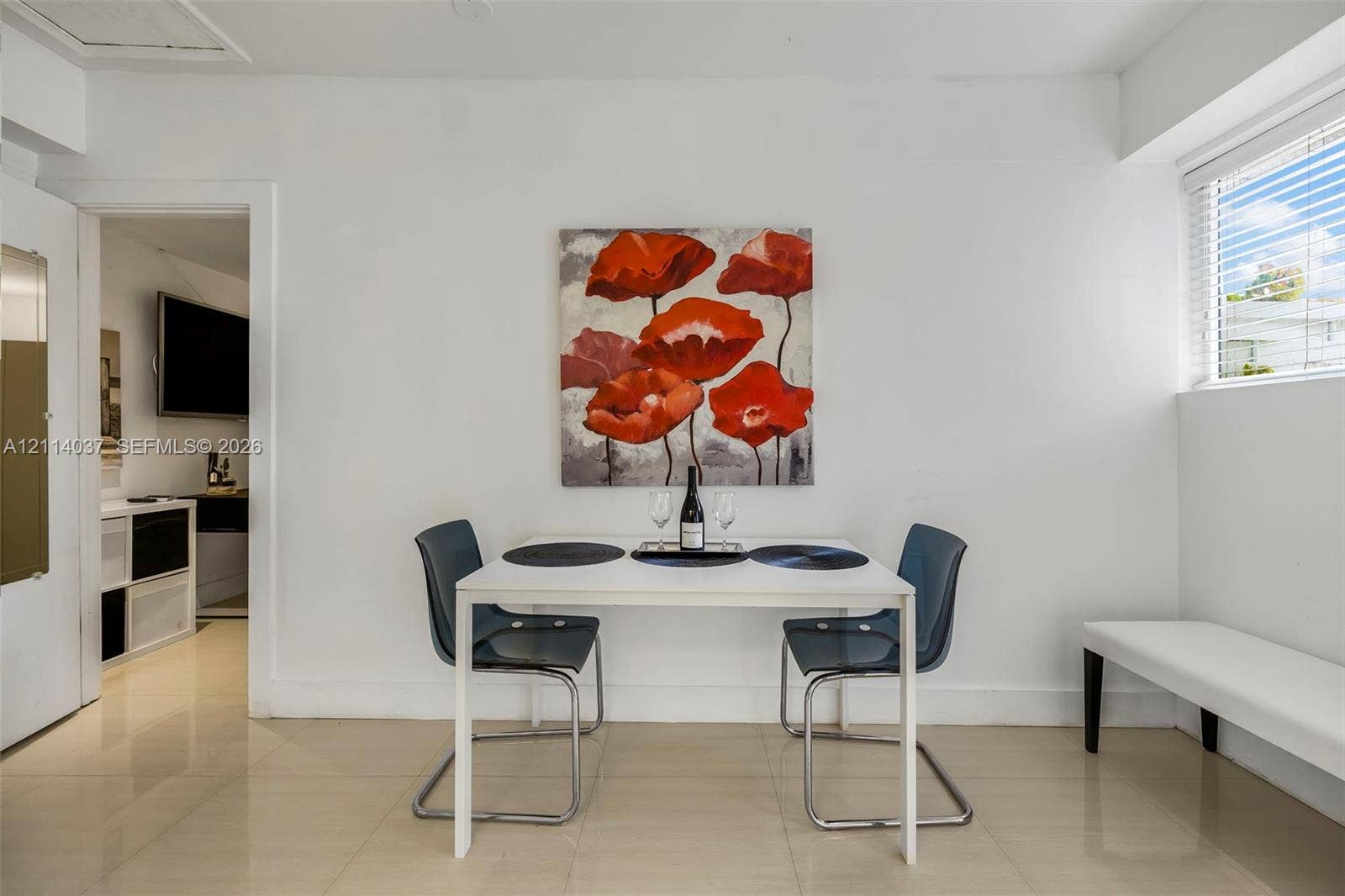 8436 SW 143rd Avenue, Miami, FL 33183 Neutral-toned tile flooring, minimalist white walls, and a horizontal window with fitted blinds