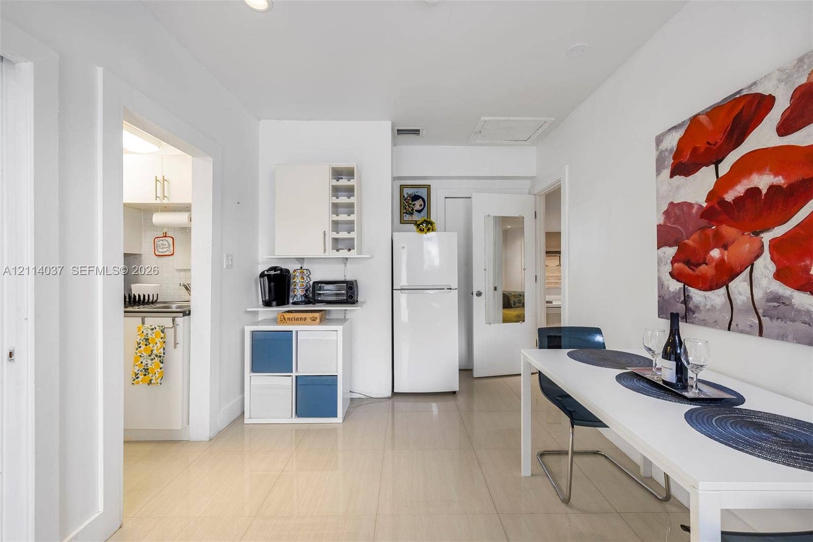 8436 SW 143rd Avenue, Miami, FL 33183 Light-toned tile flooring, white interior cabinetry, and a full-height refrigerator in a neutral-painted space
