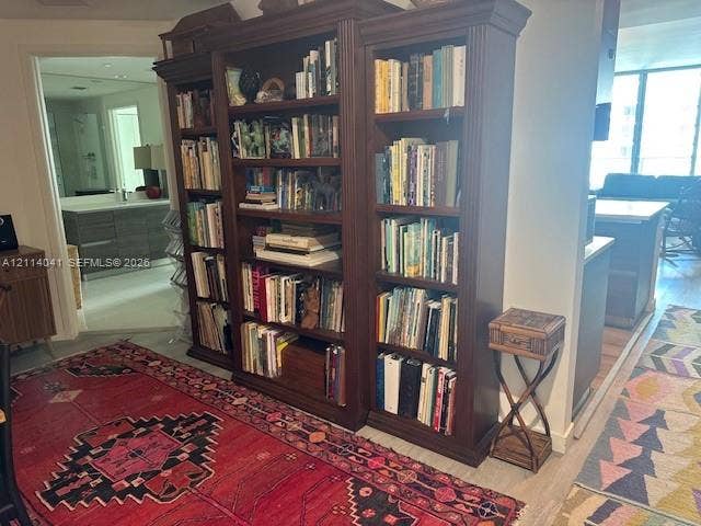 Built-in dark wood shelving unit featuring crown molding and adjustable cabinetry
