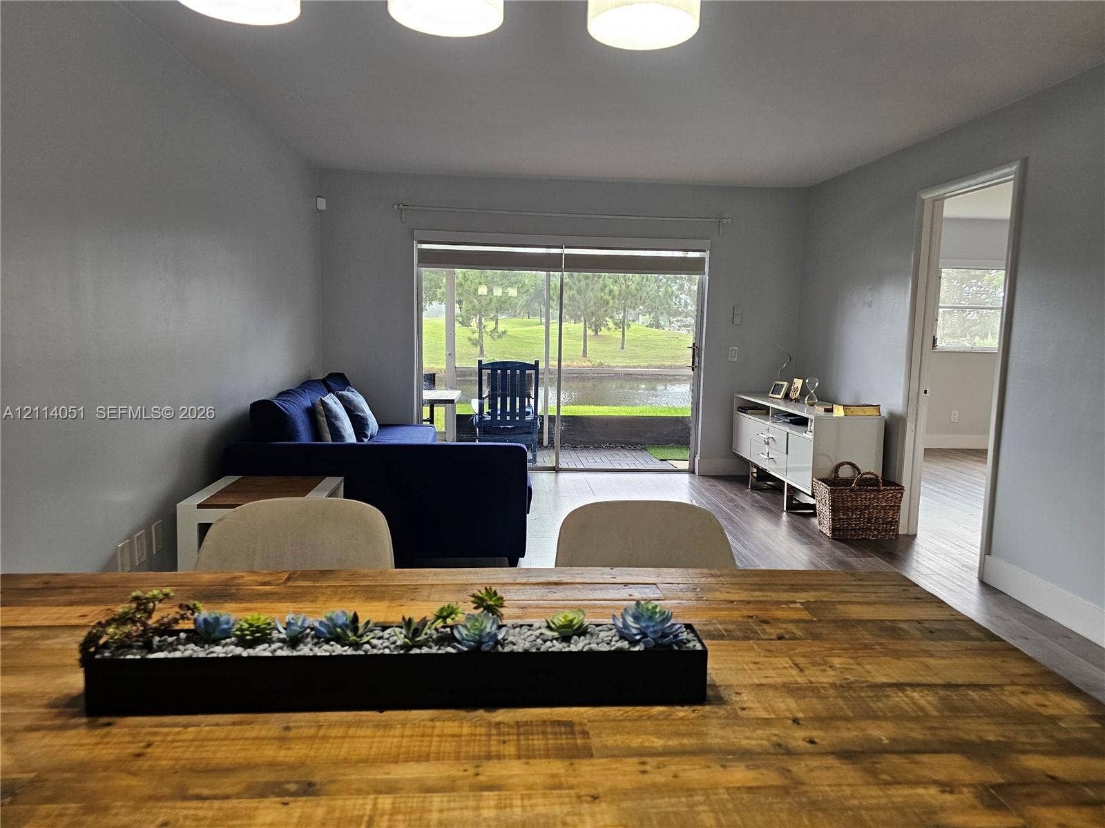2431 SW 82nd Avenue, #102, Davie, FL 33324 Living area featuring wood-finish flooring, sliding glass doors, and recessed ceiling lighting