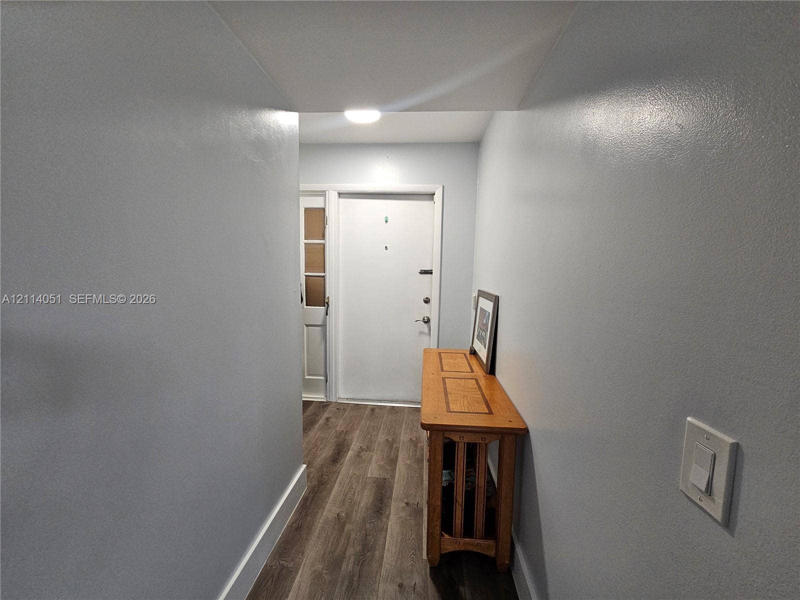 2431 SW 82nd Avenue, #102, Davie, FL 33324 Entry area featuring wood-finish flooring, smooth-finish neutral wall paint, recessed ceiling lighting, and a multi-lite exterior entry door