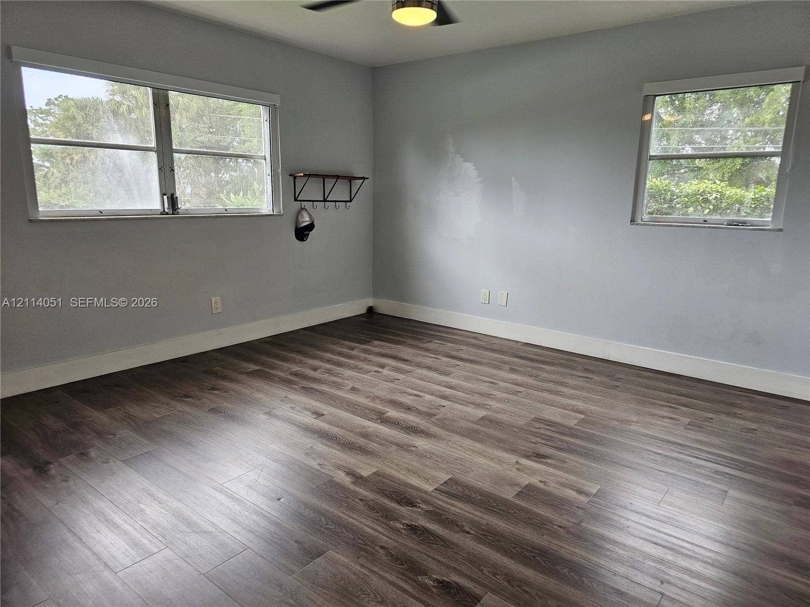 2431 SW 82nd Avenue, #102, Davie, FL 33324 Wood-finish flooring, neutral wall tones, multi-pane windows, and a ceiling-mounted light fixture