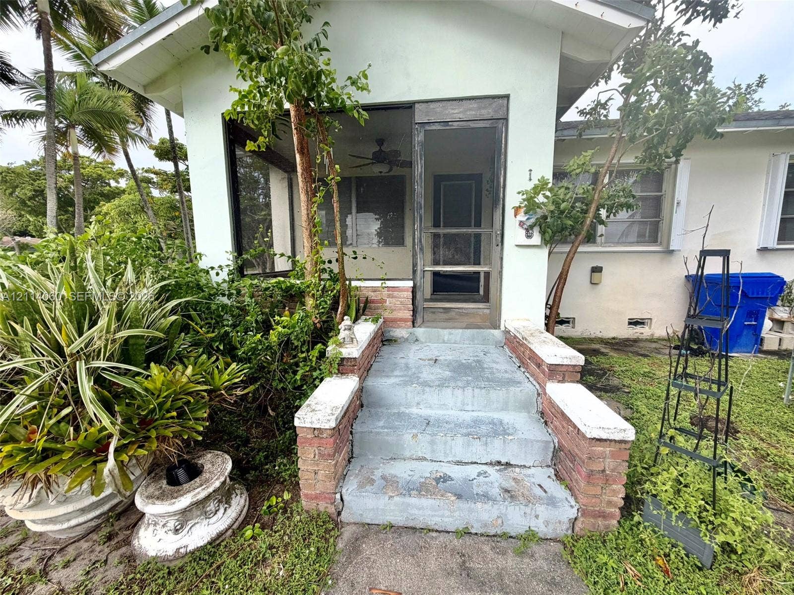 2325 Fillmore Street, #1, Hollywood, Hollywood, FL 33020 Screened porch entrance featuring concrete steps with decorative masonry brick pillars and a ceiling fan