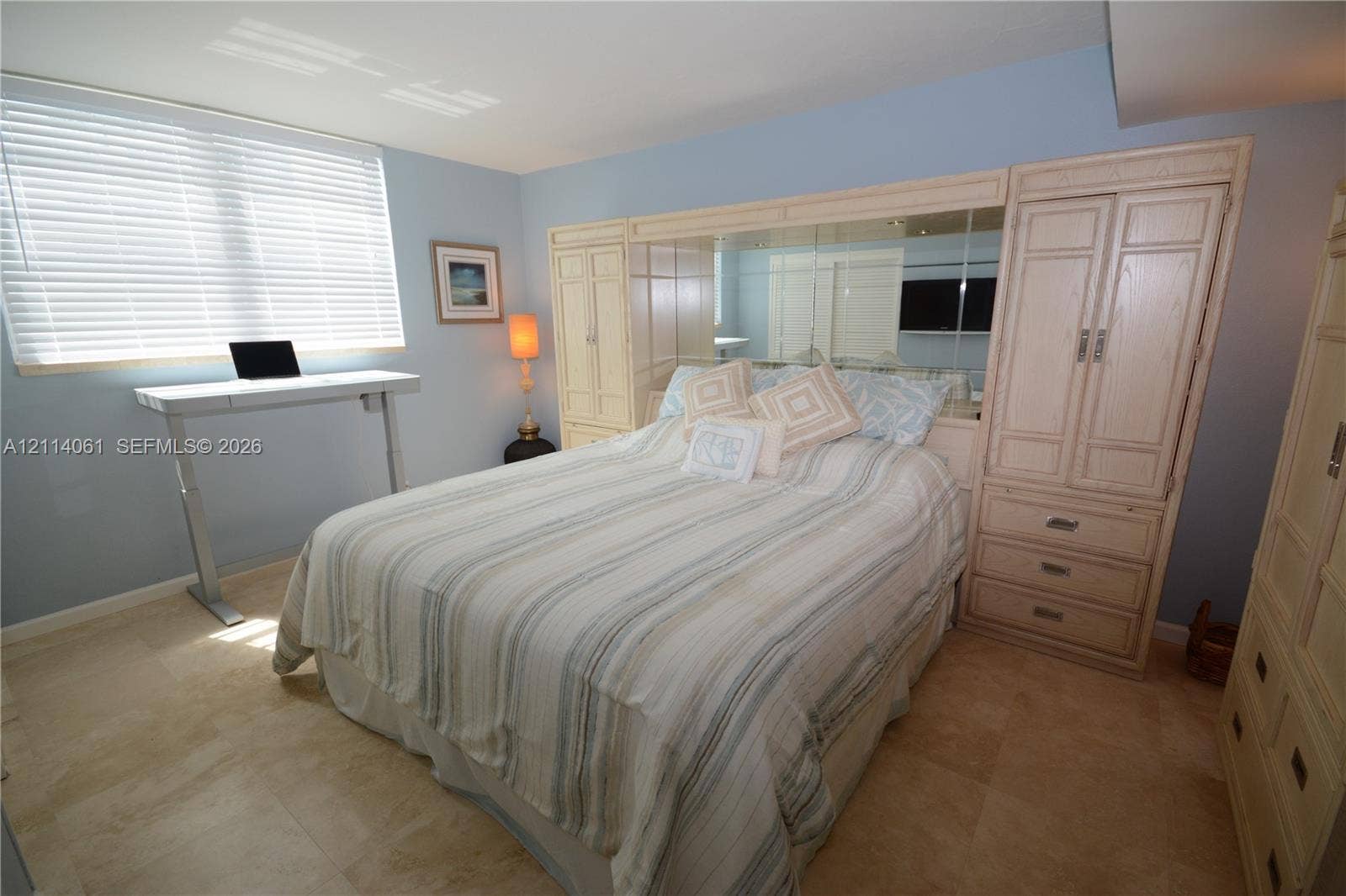 3001 S Ocean Drive, #727, Hollywood, FL 33019 Neutral-toned stone flooring and custom floor-to-ceiling built-in cabinetry with integrated mirrored accents