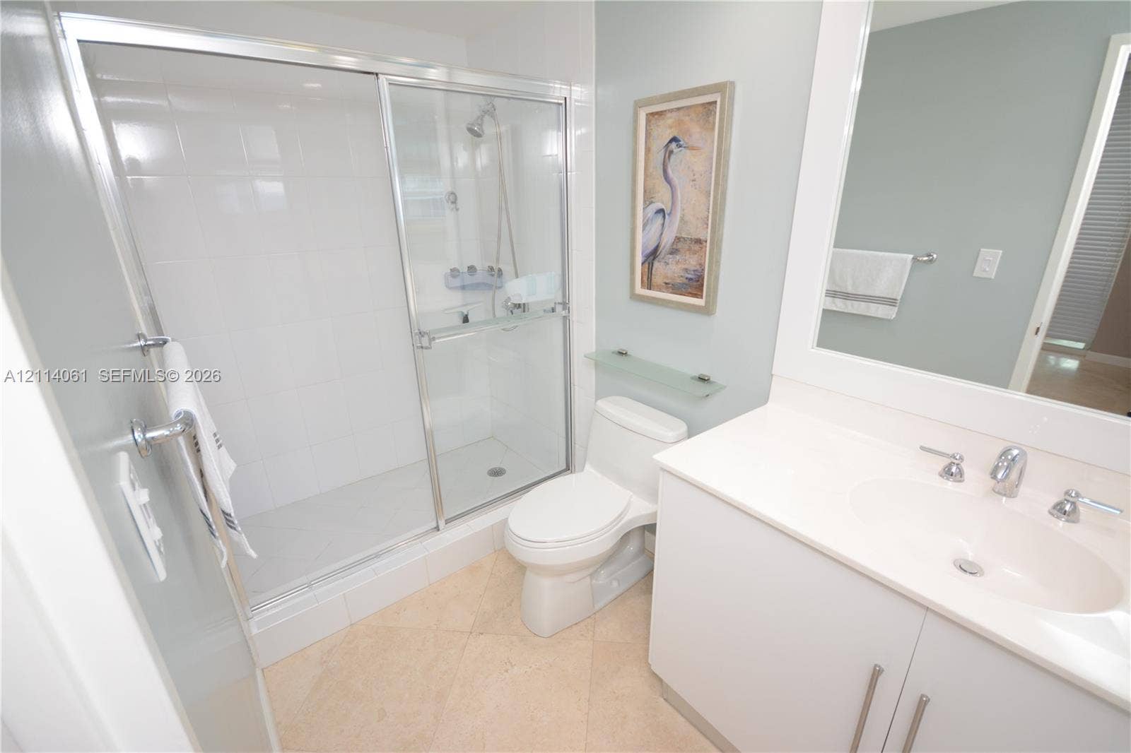 3001 S Ocean Drive, #727, Hollywood, FL 33019 Bathroom featuring a glass-enclosed shower with tiled walls, a white vanity with an integrated basin, a polished-chrome faucet, and tile flooring