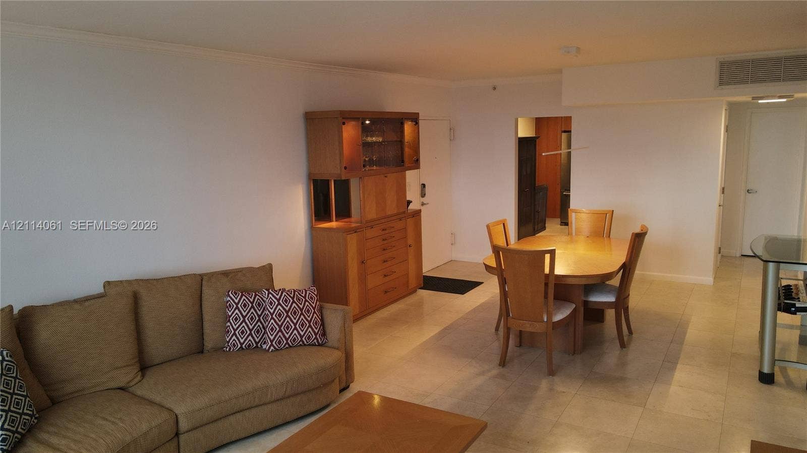 3001 S Ocean Drive, #727, Hollywood, FL 33019 Open-concept interior featuring neutral tile flooring, recessed lighting, and a built-in wooden cabinetry unit