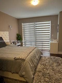 Sliding glass door featuring adjustable horizontal light-filtering shades and wood-finish flooring