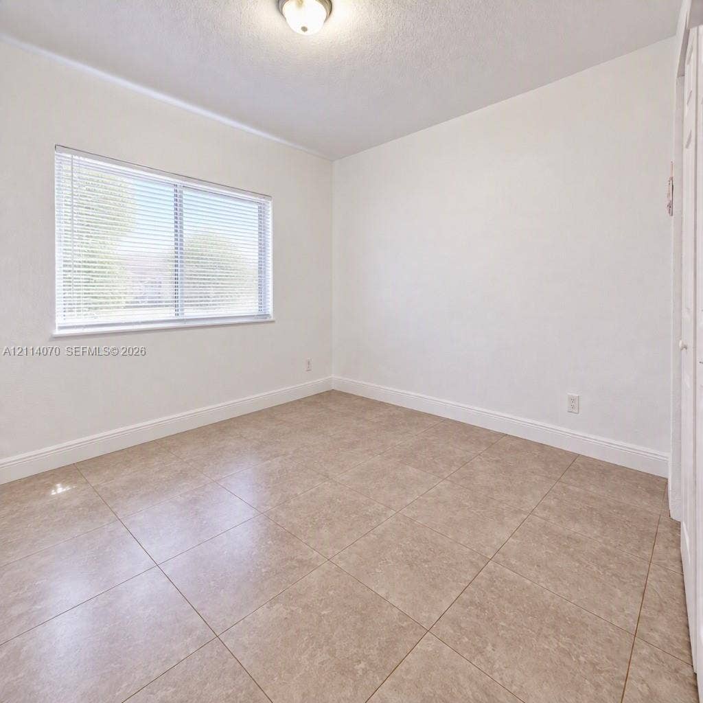 15400 SW 284th Street, #1204, Homestead, Homestead, FL 33033 Neutral-toned ceramic tile flooring, crisp white wall finish, recessed overhead lighting, and dual-pane window with integrated blinds