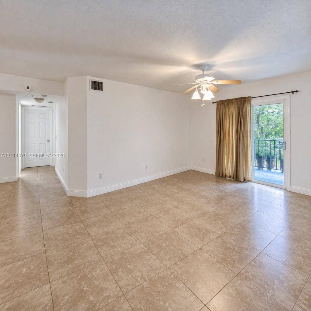 15400 SW 284th Street, #1204, Homestead, Homestead, FL 33033 Interior space featuring large-format ceramic tile flooring, a multi-light ceiling fan, and sliding glass doors providing access to an outdoor balcony