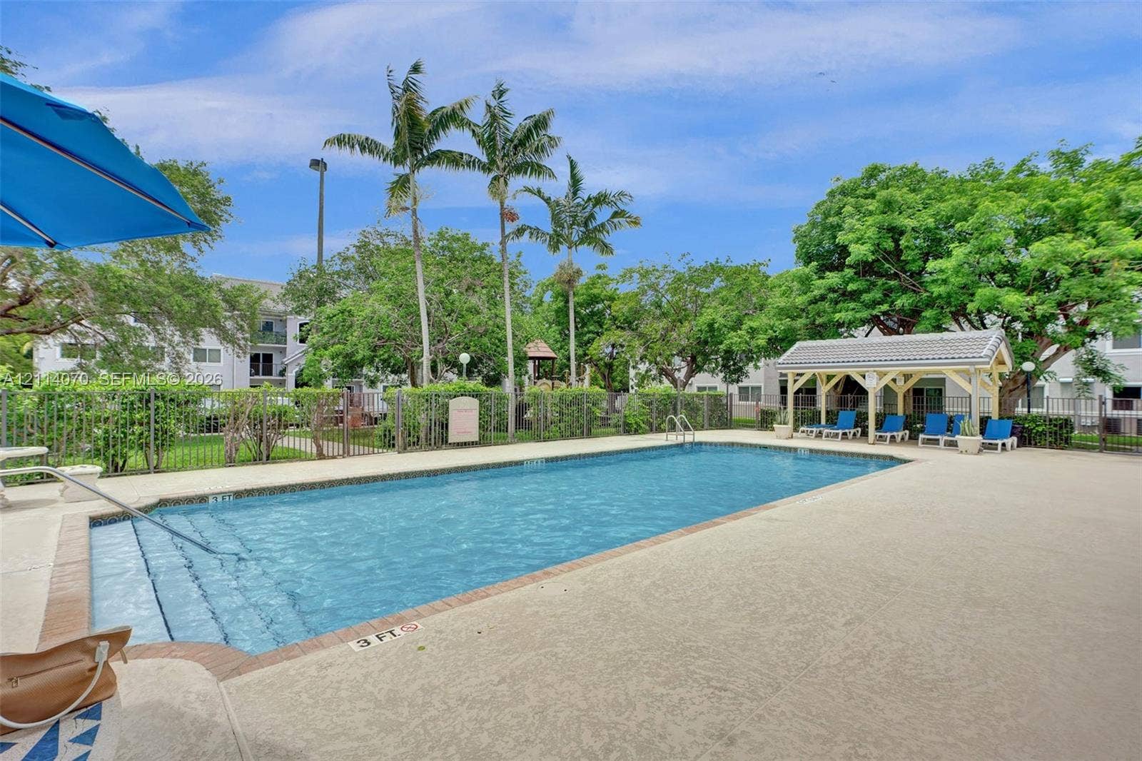 15400 SW 284th Street, #1204, Homestead, Homestead, FL 33033 Outdoor swimming pool featuring a concrete deck, built-in metal handrails, and a covered pavilion structure