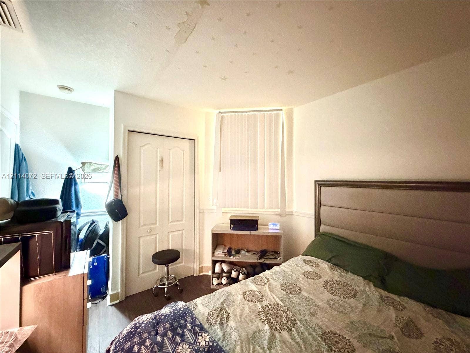 8964 W Flagler Street, #107, Miami, Miami, FL 33174 Room featuring wood-finish flooring, a double-door closet, a window with vertical blinds, and chair rail molding