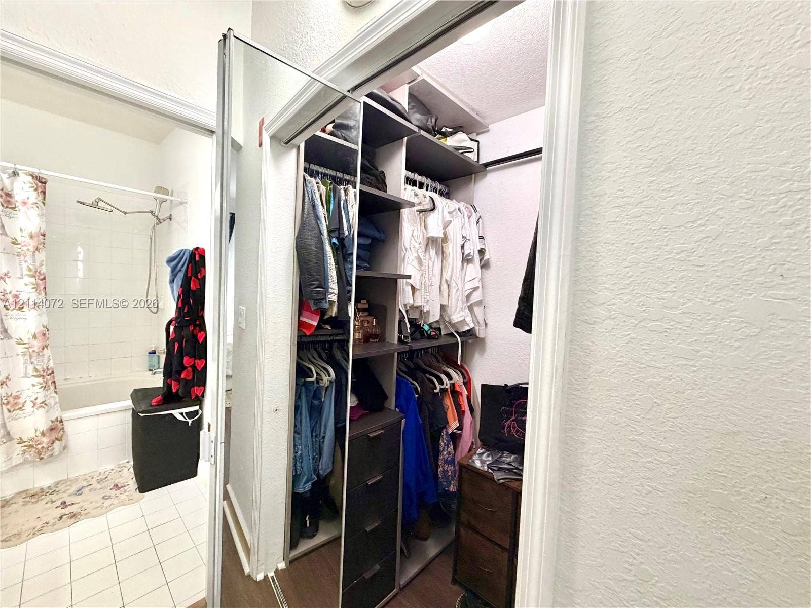 8964 W Flagler Street, #107, Miami, Miami, FL 33174 Built-in walk-in closet featuring multi-tiered shelving, hanging rods, and integrated drawer storage