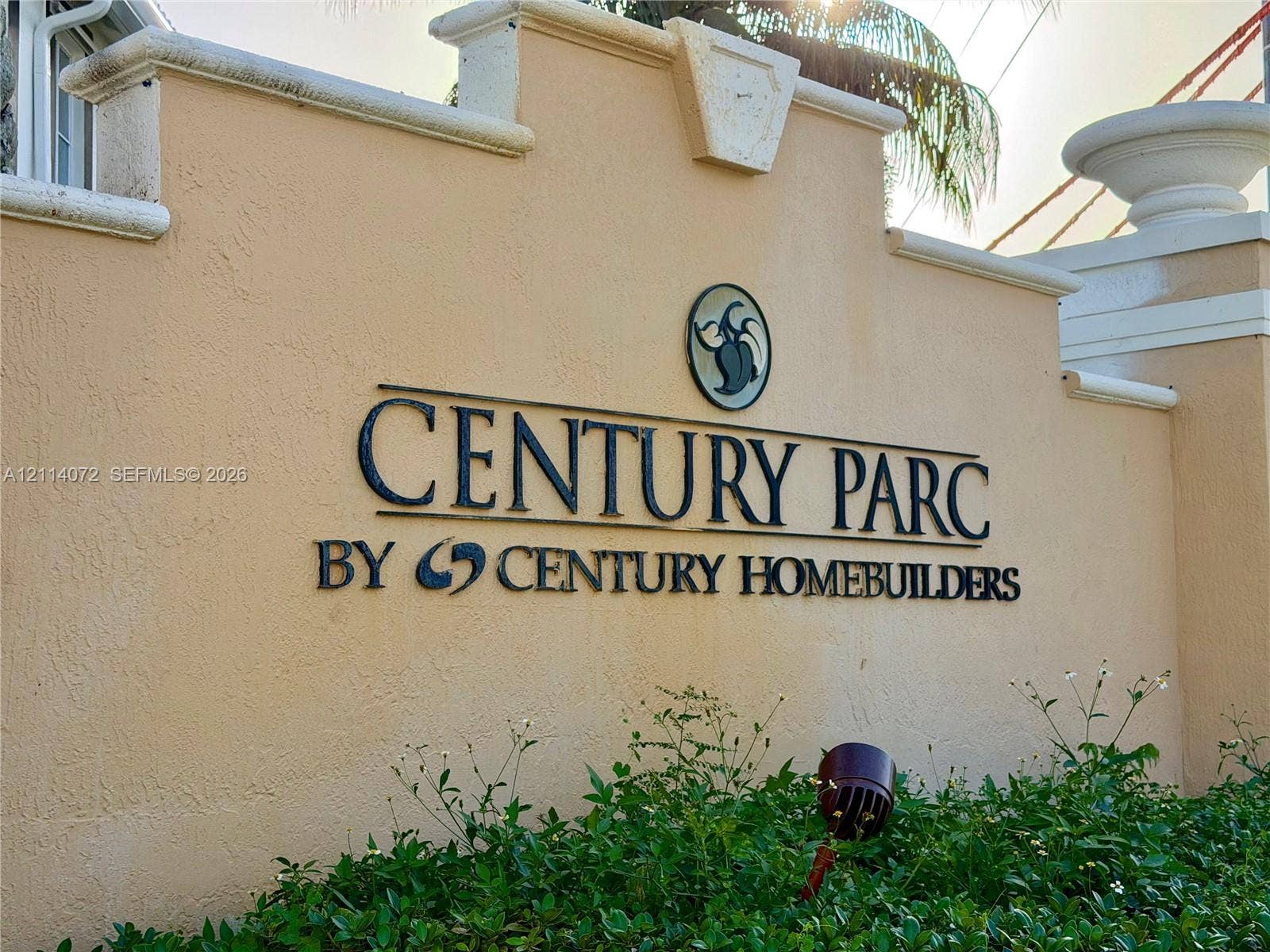 8964 W Flagler Street, #107, Miami, Miami, FL 33174 Stucco community monument wall featuring dimensional lettering, decorative masonry caps, and a landscape buffer