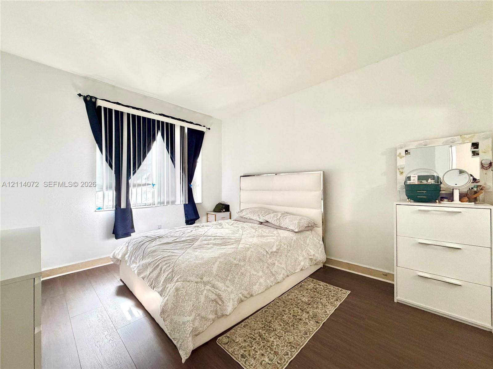 8964 W Flagler Street, #107, Miami, Miami, FL 33174 Wood-finish flooring and a single-pane window with vertical blinds