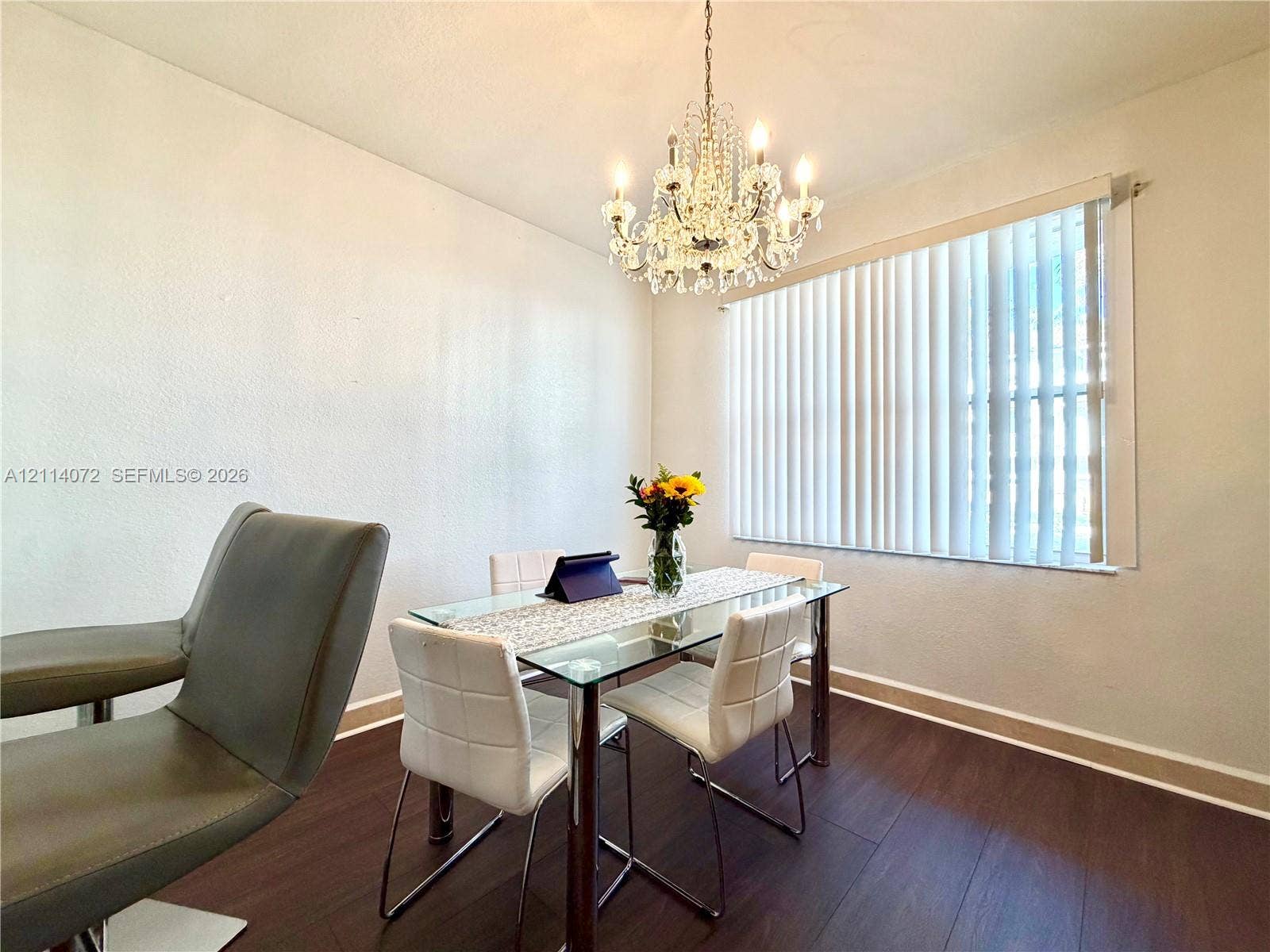 8964 W Flagler Street, #107, Miami, Miami, FL 33174 Wood-finish flooring, crystal-style chandelier, and vertical blinds