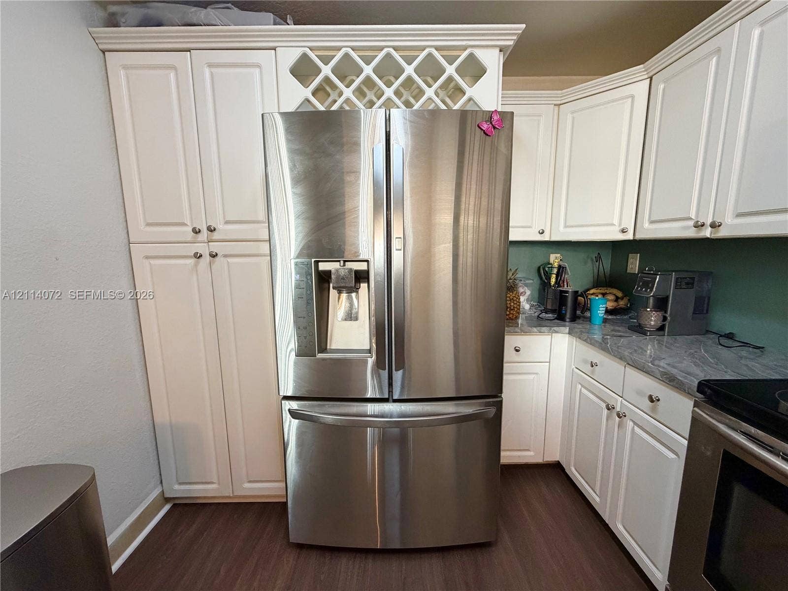 8964 W Flagler Street, #107, Miami, Miami, FL 33174 Kitchen featuring white shaker-style cabinetry, stainless steel French-door refrigerator, integrated wine rack, stone-finish countertops, and wood-finish flooring