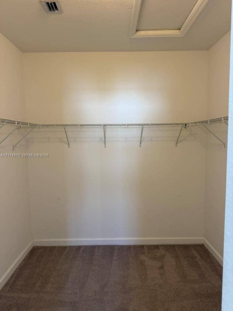 2659 SE 11th Street, Homestead, FL 33035 Walk-in closet featuring neutral carpeting and built-in wire shelving