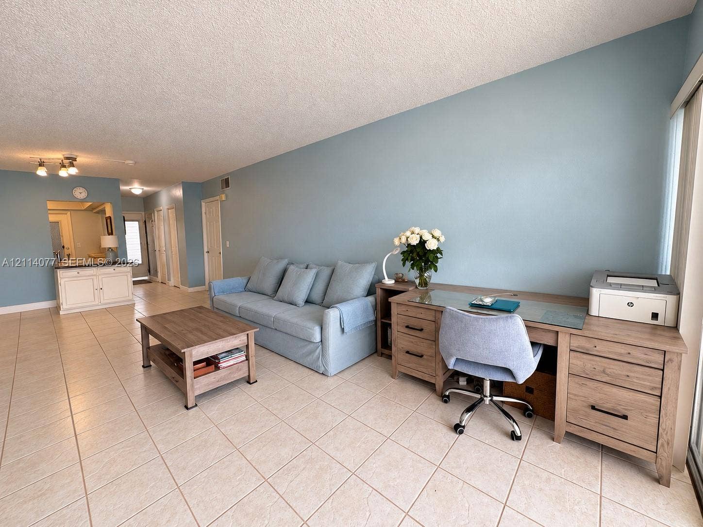 465 Paradise Isle Boulevard, #206, Hallandale Beach, Hallandale Beach, FL 33009 Open-concept living space featuring large-format ceramic tile flooring, neutral wall paint, and a built-in cabinetry unit with a countertop