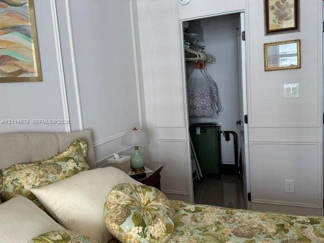 Interior room featuring decorative wall molding and a built-in closet with integrated shelving