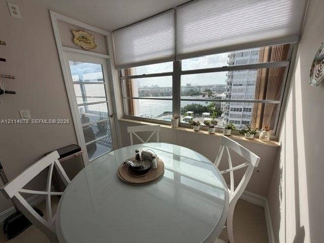 Multi-pane horizontal sliding windows, stone windowsill, full-light glass door, and cellular window shades