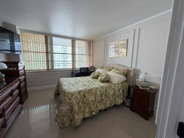 Wall molding detailing, large-format tile flooring, and floor-to-ceiling windows featuring vertical blinds