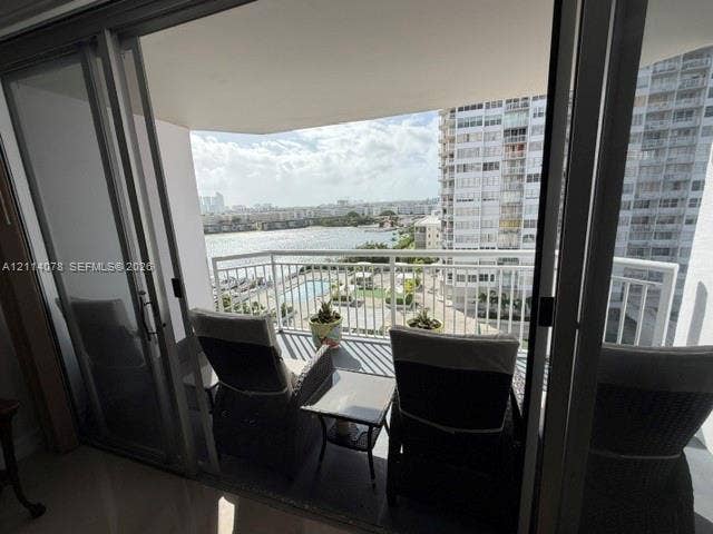 Private balcony featuring aluminum railing and sliding glass door entry