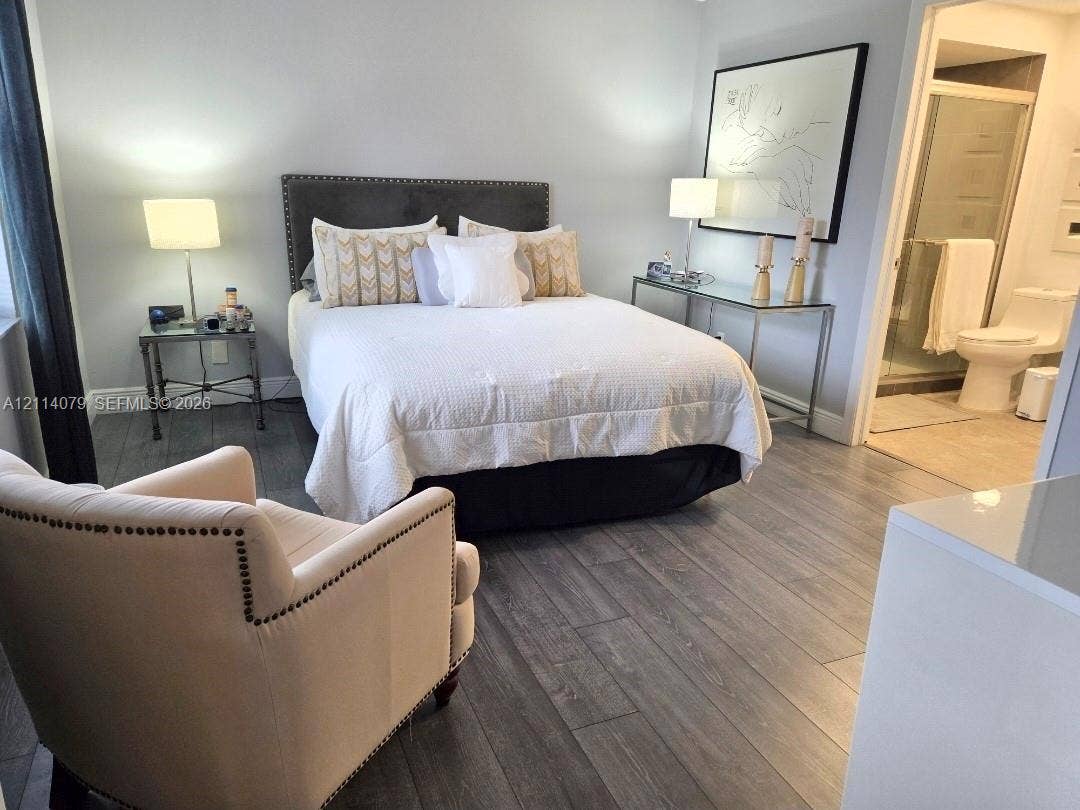 9241 Sunrise Lakes Boulevard, #109, Sunrise, FL 33322 Wood-finish flooring, glass-enclosed shower, and neutral wall color palette