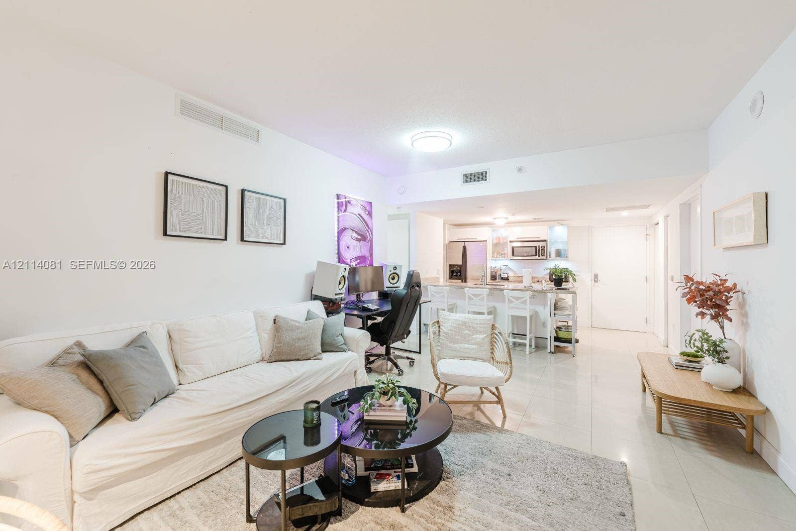 185 SW 7th Street, #3609, Miami, Miami, FL 33130 Living area featuring large-format tile flooring, recessed lighting, and a kitchen peninsula with integrated seating