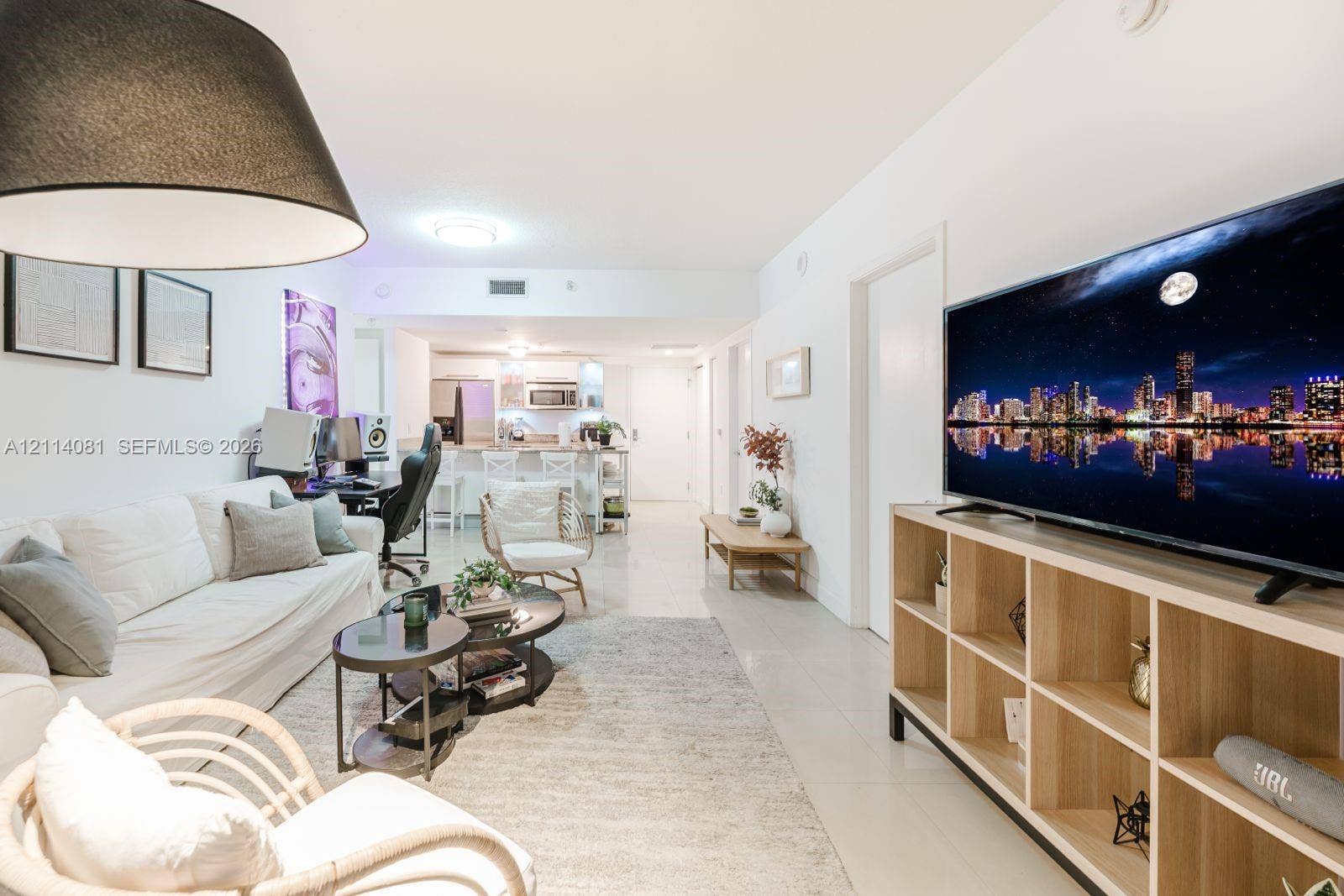 185 SW 7th Street, #3609, Miami, Miami, FL 33130 Open-concept interior featuring light-toned tile flooring, recessed lighting, and a kitchen equipped with a breakfast bar