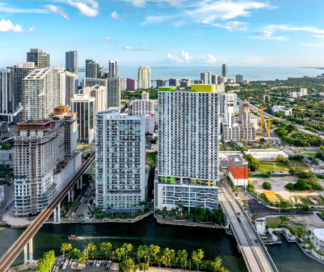 185 SW 7th Street, #3609, Miami, Miami, FL 33130 High-rise building featuring private balconies, floor-to-ceiling windows, and waterfront positioning within an urban landscape