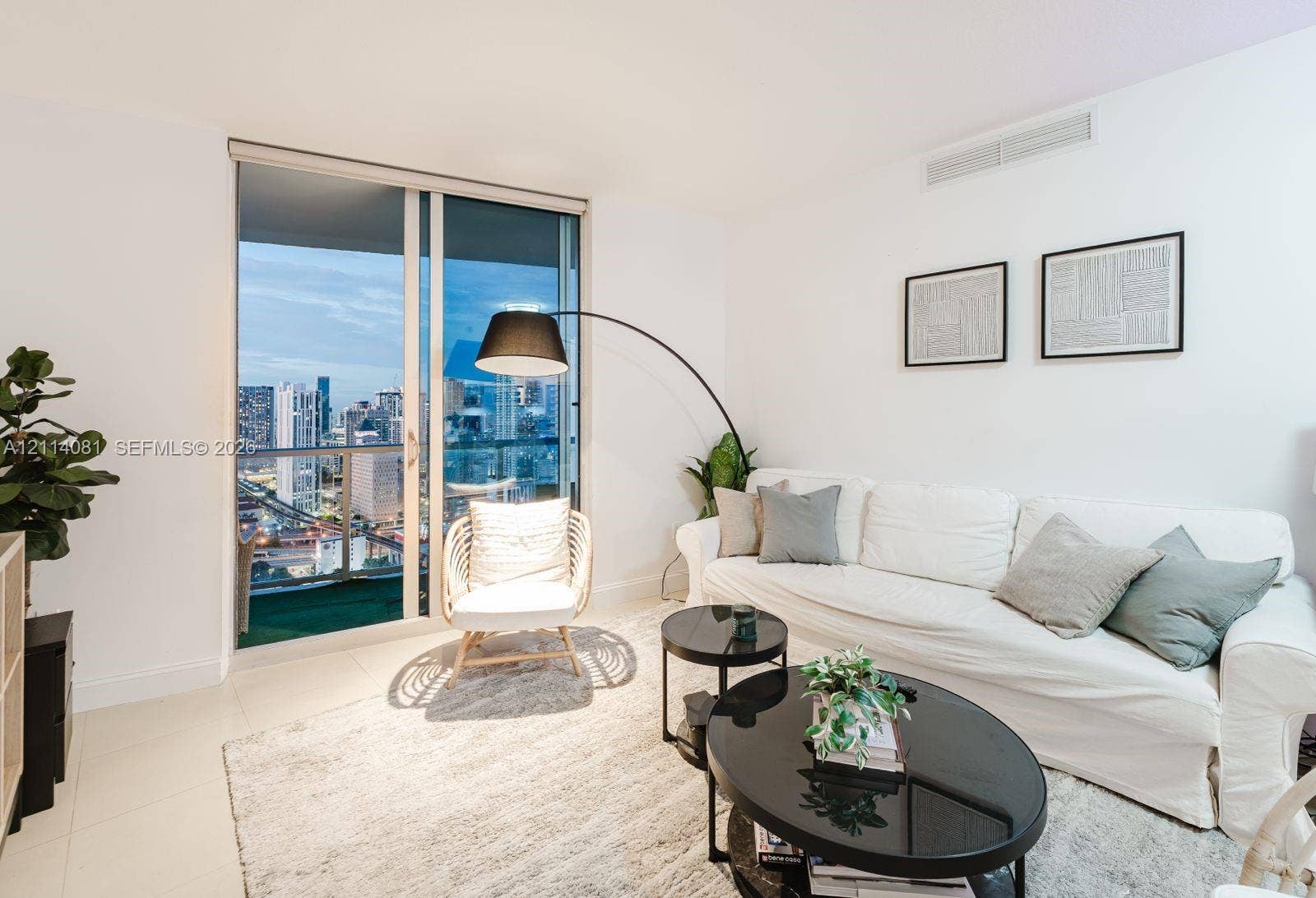 185 SW 7th Street, #3609, Miami, Miami, FL 33130 Full-height sliding glass door, neutral floor tiles, and urban skyline backdrop